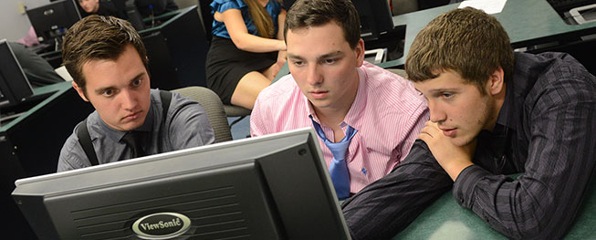 The three junior achievement champions, Jacob Scoccimerra, Joe Cippel and Aaron Shaner manage their virtual company in a computer lab.
