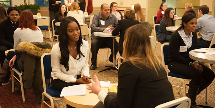 In a room in Lawrence Hall, Point Park students engage in conversations with alumni and other working professionals at an event called 