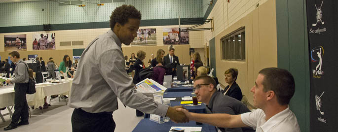 Pictured is a Point Park student shaking hands with an employer at the sport, arts, entertainment, and media career event.