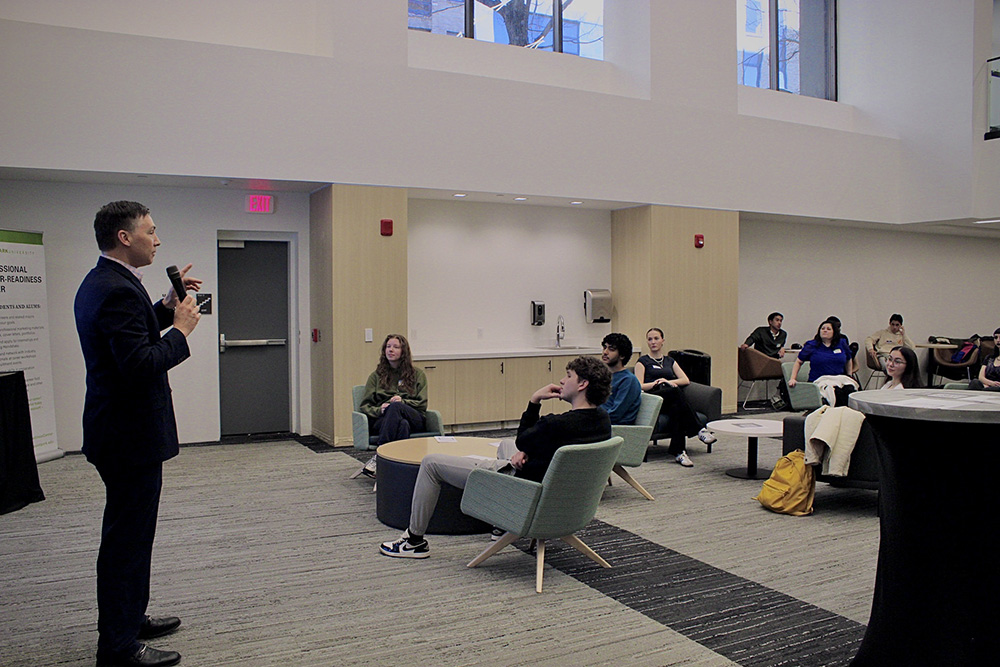 Pictured is Dean Jolin speaking to students and alumni at a networking event. Photo by Kelli Strate.
