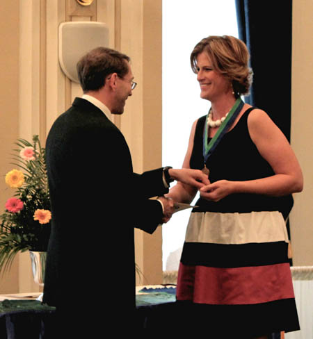 Point Park student Janette Maple receives the Alpha Chi medal from Prof. Don Keller. 
