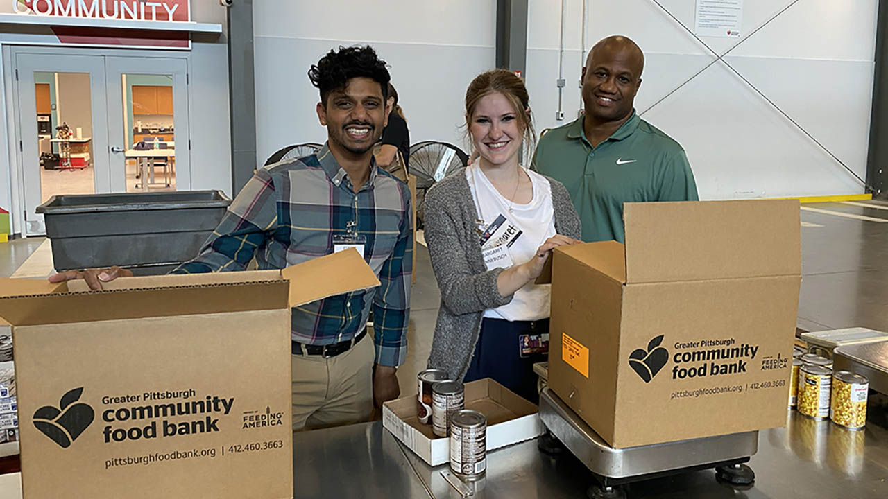 Pictured are students Esrom Williams, Jr., Margaret Hinnebusch and Leroy Headen at the Greater Pittsburgh Community Food Bank. Each year, the Ph.D. in Community Engagement program holds a welcome weekend for new students to meet their cohort and other students in the program as they participate in volunteer activities and a research symposium. 