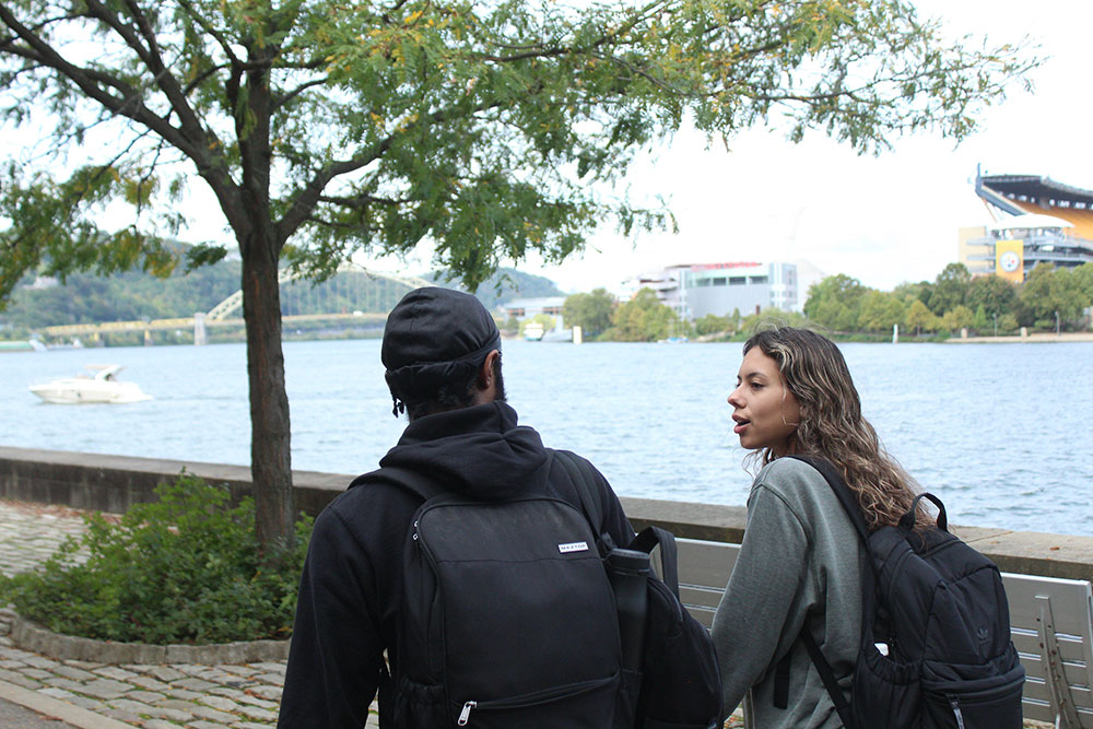 Students walk along the Allegheny River.