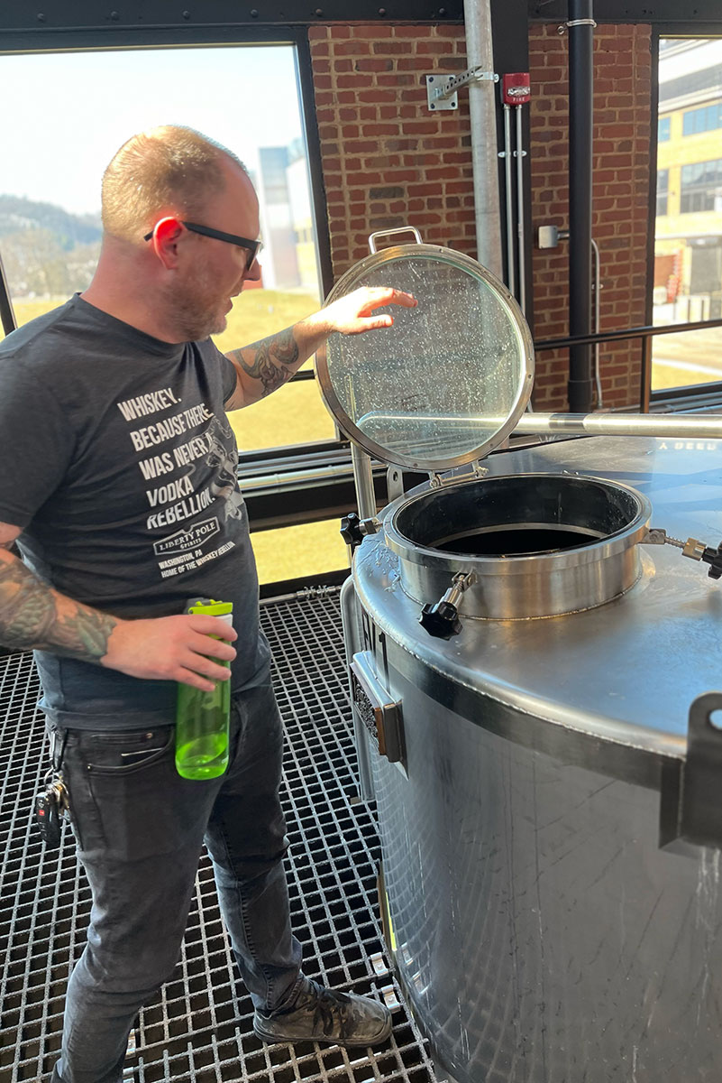 A man checks a distilling machine