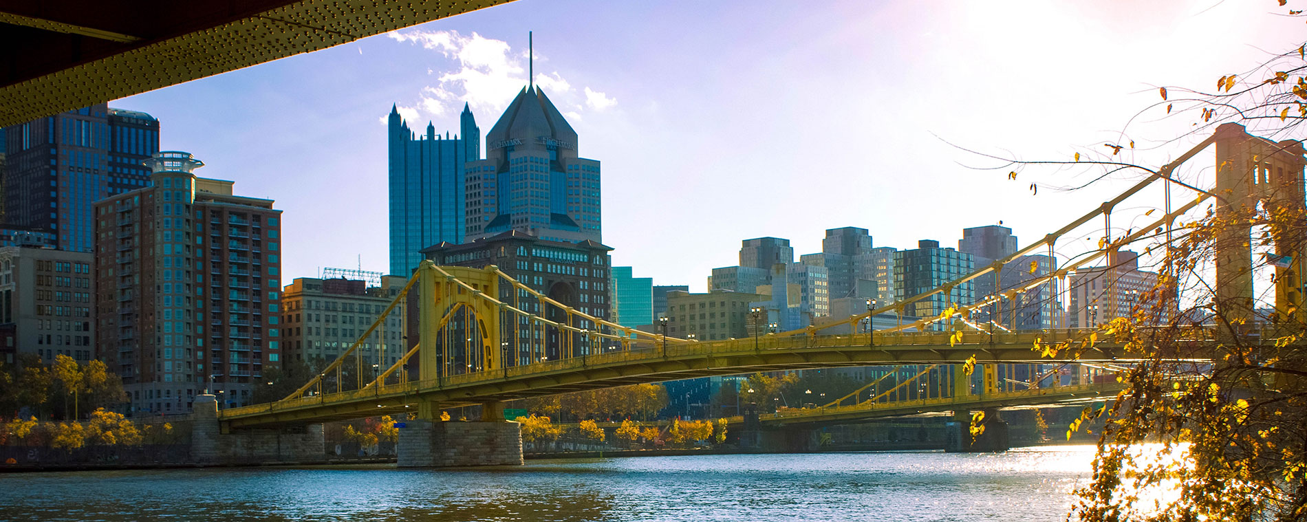 A photo of a bridge and downtown Pittsburgh skyline