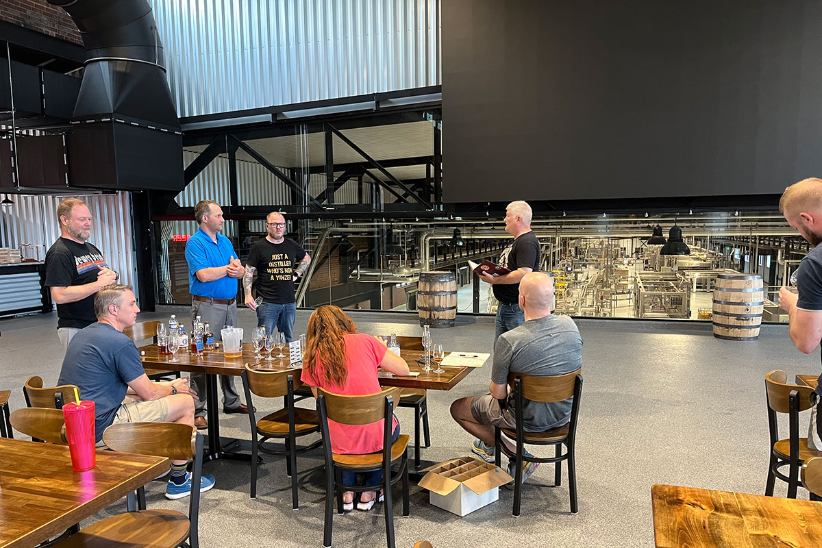 People listen to a lecture above a distilling room.