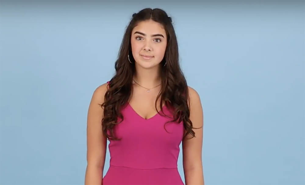 Screenshot of framing criteria shows a girl with long hair in the middle of a black blue background. Framing is about two inches above her head and stops just below the waist.