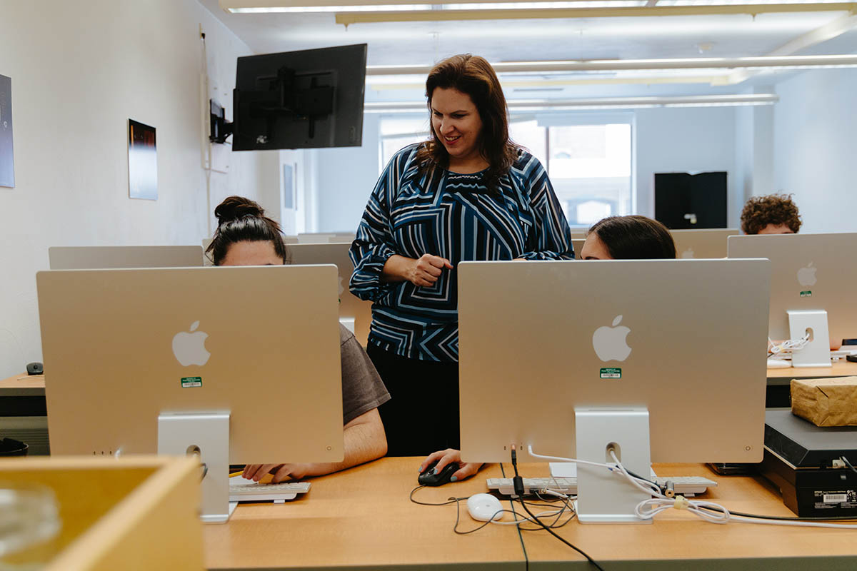 Students work with Instructor Karen Dolgos at the Graphic Design Summer Workshop. Photo | Nadia Jones