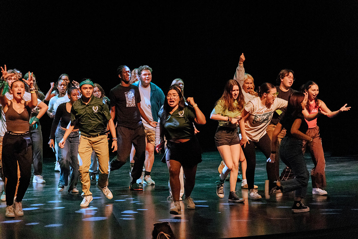 Students dance on a stage.