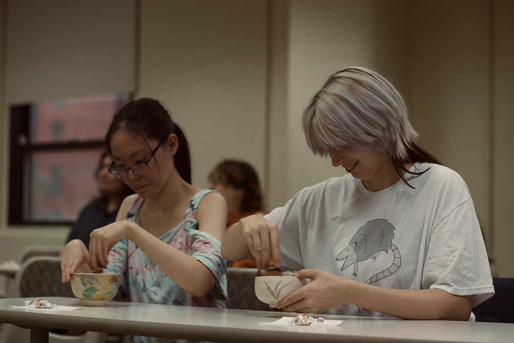 Two students whisk matcha in the Japanese Culture course. Photo by Rosita Grigaite.