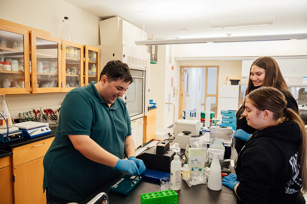 Pictured is Lab Associate Brandon Dimick working with students in a lab. Photo by Ethan Stoner. 