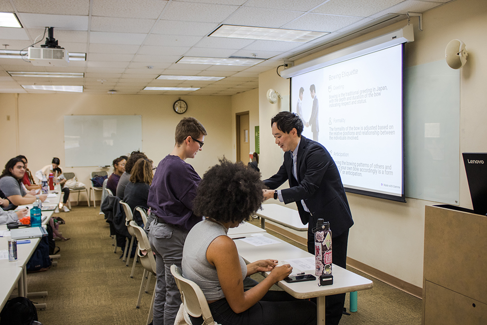 Pictured is Logre Abdis exchanging business cards with a guest speaker. Photo by Nadia Jones.