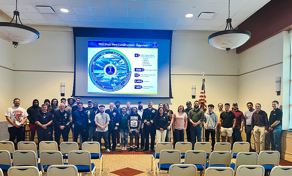 Engineering students and faculty pose for a photo with U.S. Navy Rear Admiral Thomas Anderson and other representatives from the Navy. Photo by Nadia Jones.