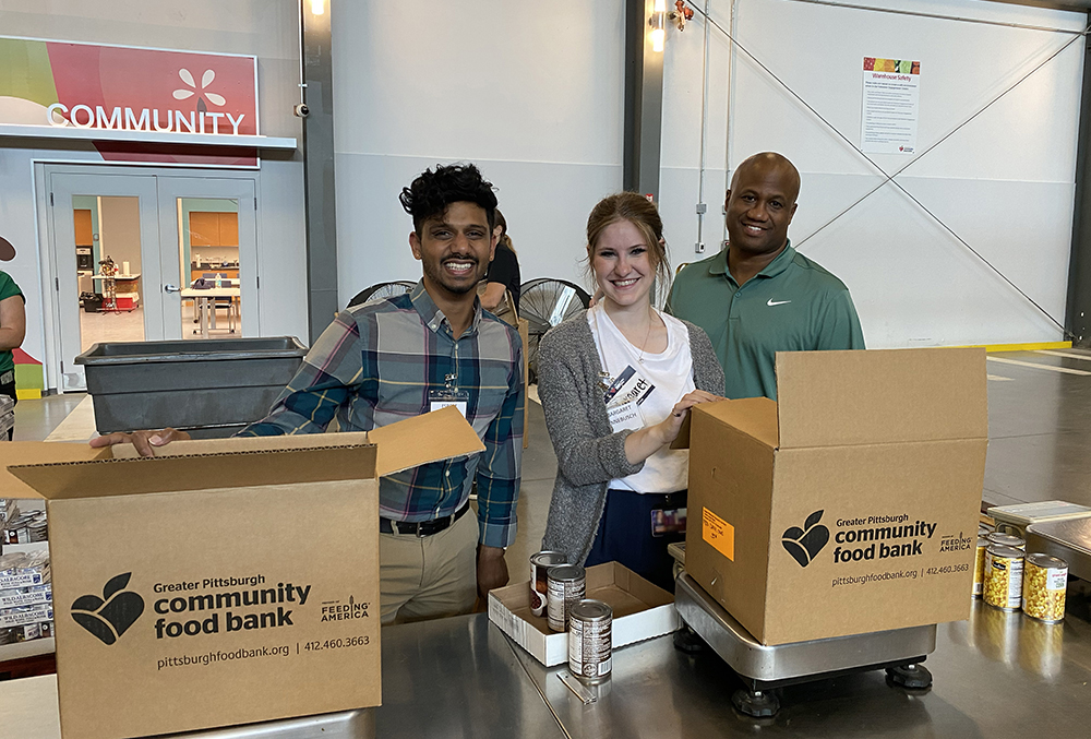 Pictured are students Esrom Williams, Margaret Hinnebusch and Leroy Headen at the Greater Pittsburgh Community Food Bank. Photo by Nicole Chynoweth.