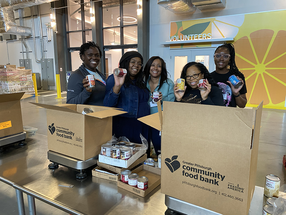 Pictured are Ph.D. in Community Engagement students volunteering at the Greater Pittsburgh Community Food Bank. Photo by Nicole Chynoweth.