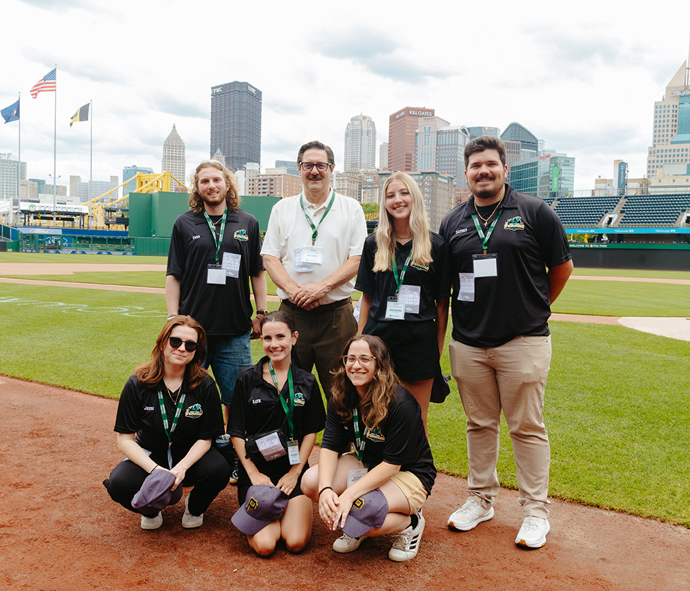 Camp counselors pose for a photo with Professor Robert Derda at PNC Park. Photo by Ethan Stoner.
