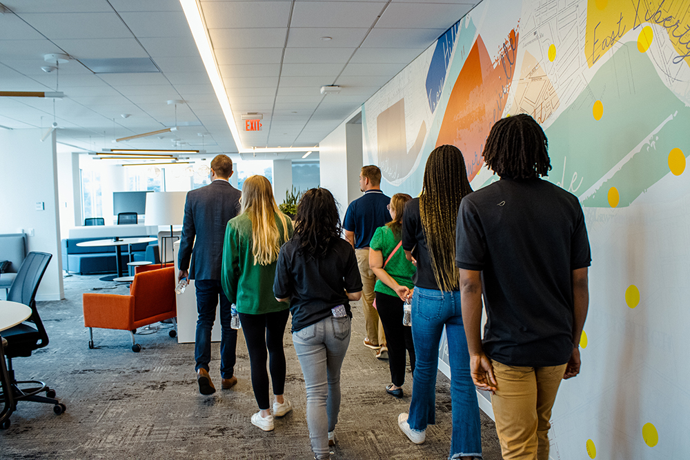 Students walk through EY's office during a site visit. Photo by Nadia Jones.