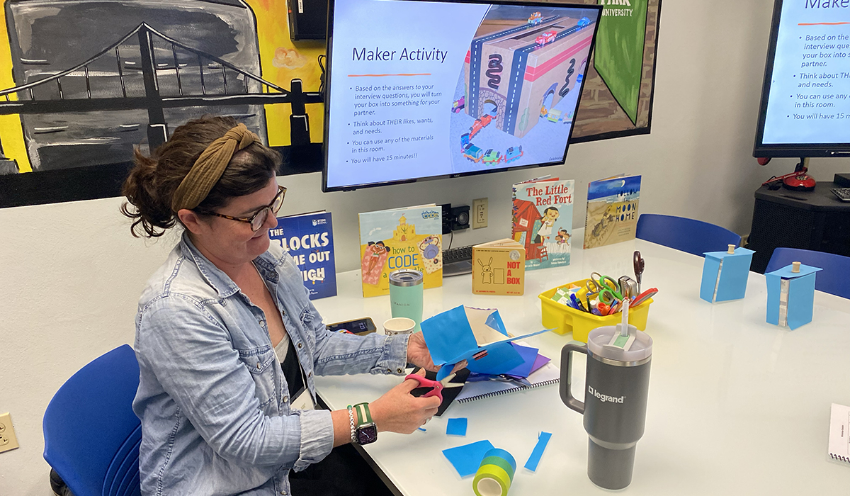 An attendee works on a maker space activity during the C.A.R.E. Wellness Symposium. Photo by Nicole Chynoweth.