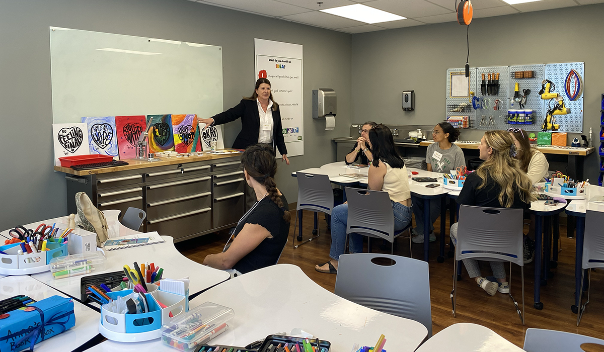 Alisa Whysong describes the mission of The Positive Painting Project during a workshop session at the C.A.R.E. Wellness Symposium. Photo by Nicole Chynoweth.