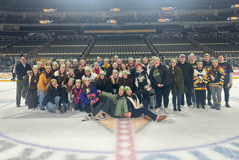 A large group of students on the ice after a Penguins Game.