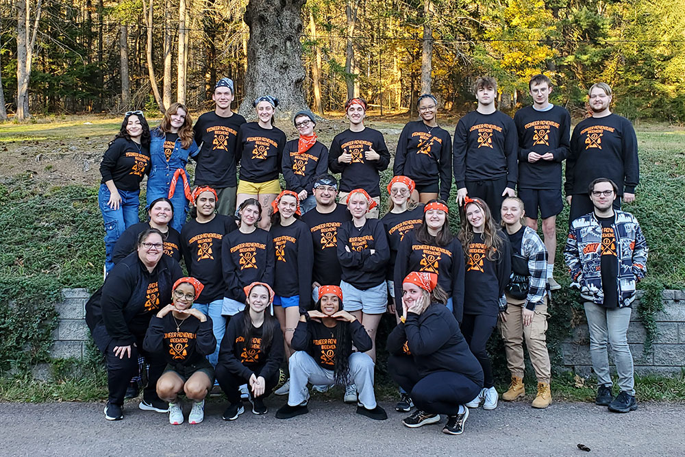 Students on the trip pose in their t-shirts.