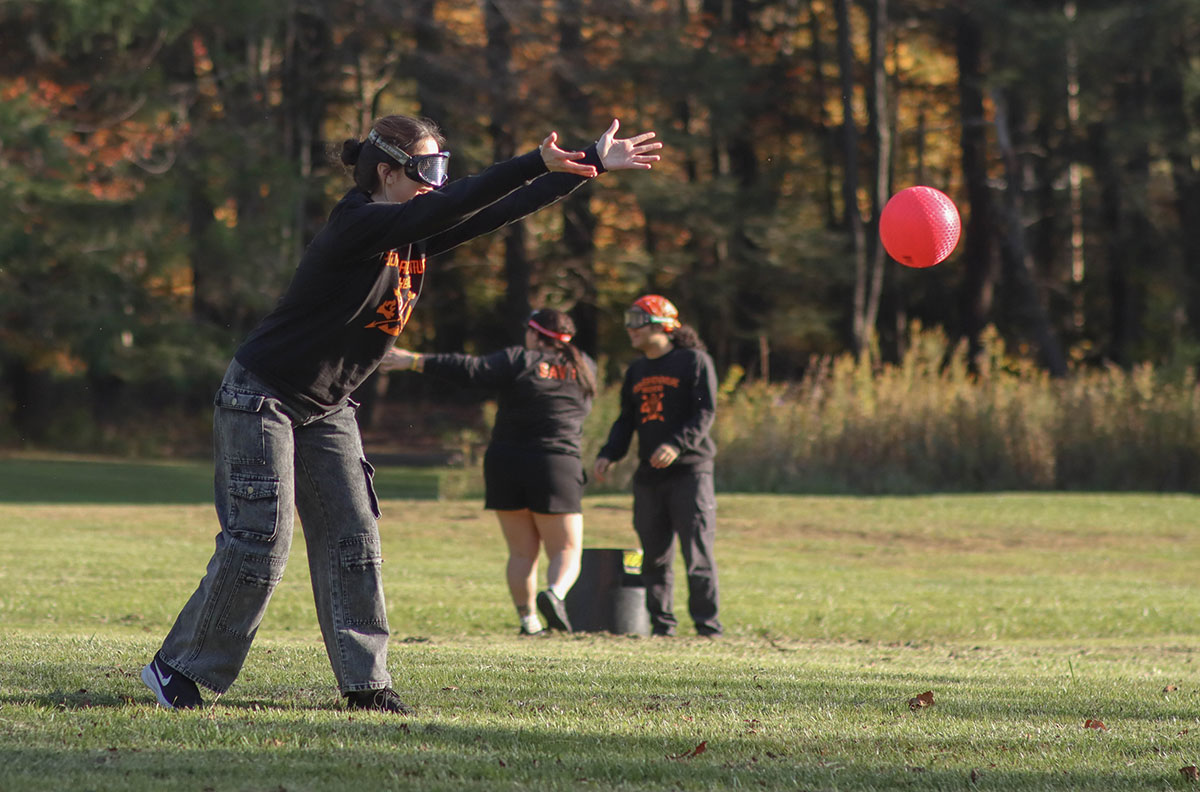 Students wearing goggles play kickball.