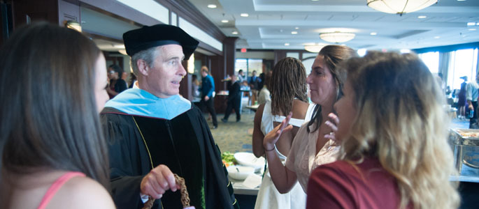 Pictured is President Paul Hennigan with Point Park students at the reception following the Convocation ceremony at Sheraton Station Square on Aug. 22, 2014. | Photo by Chris Rolinson