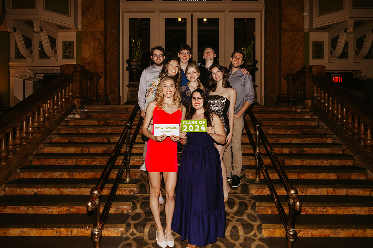 Students pose on a stairway
