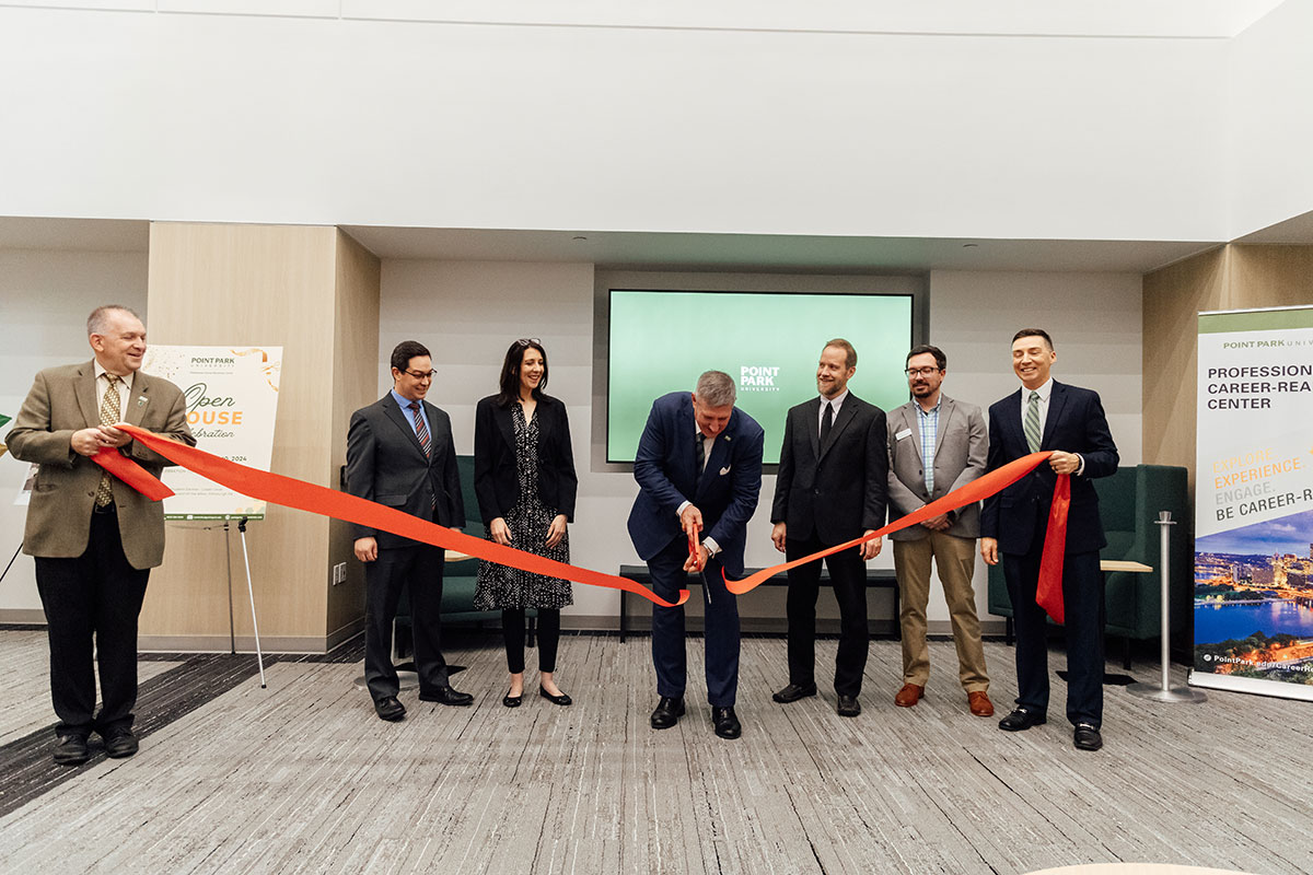 President Chris Brussalis cuts the ribbon at the PCRC opening.