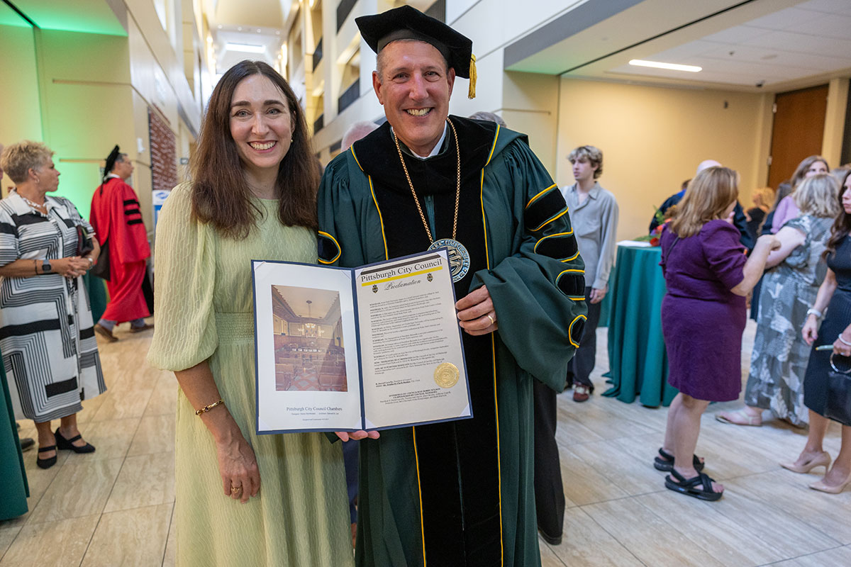 President and Mrs. Brussalis hold up the proclamation.