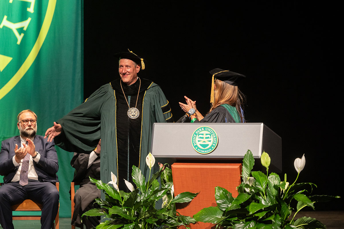 Dr. Brussalis wears the presidential medallion.