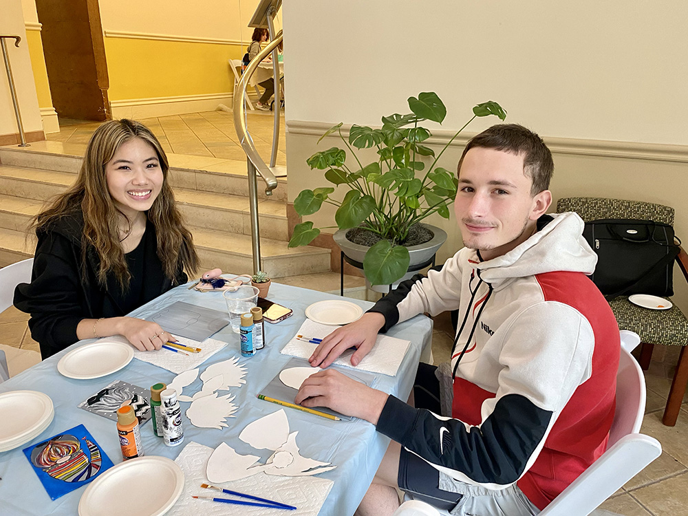 Two students participate in a painting activity at the Pioneer Pause.
