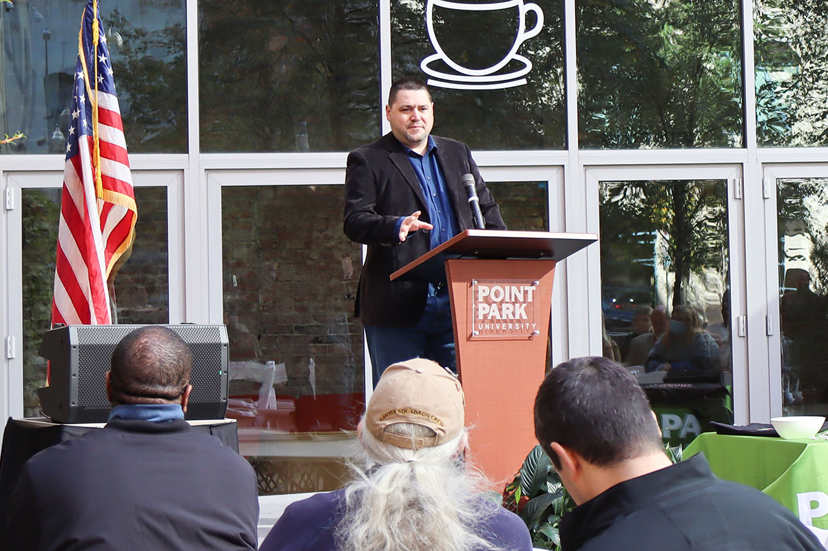 Paul McDonald stands behind a podium.