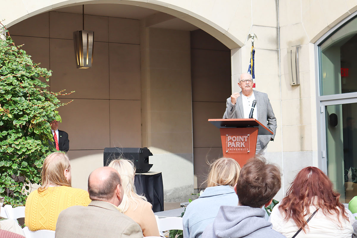 Randy Baird stands behind a podium.