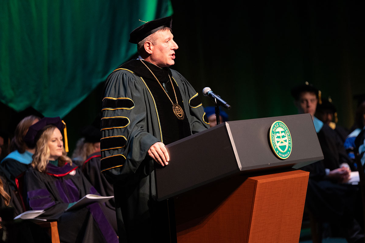 Chris Brussalis stands at the podium.