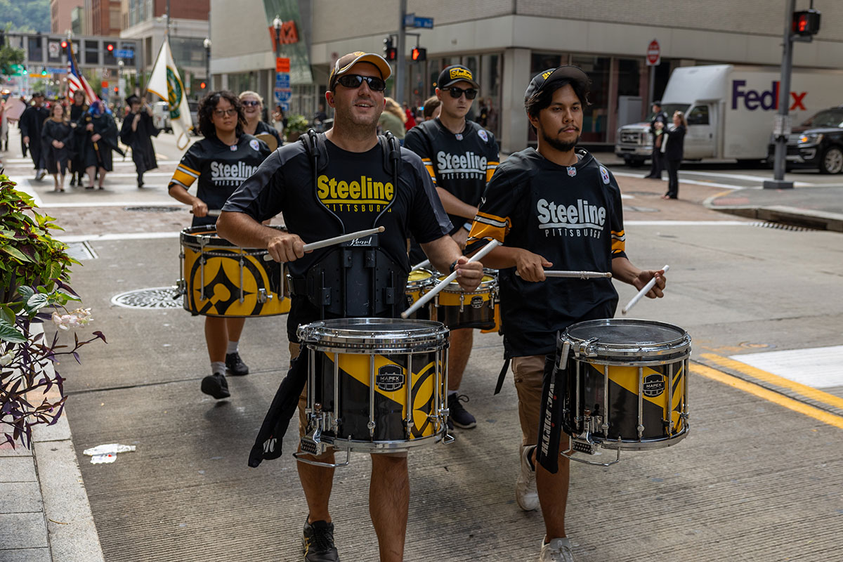 Members of the Pittsburgh Steeline march down Wood Street.