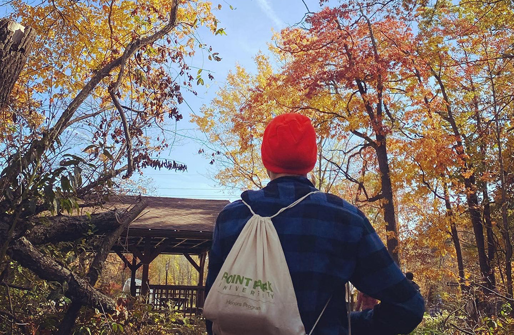 Pictured is an Honors Program student during a hike on the Rachel Carson Trail in North Park. Submitted photo.
