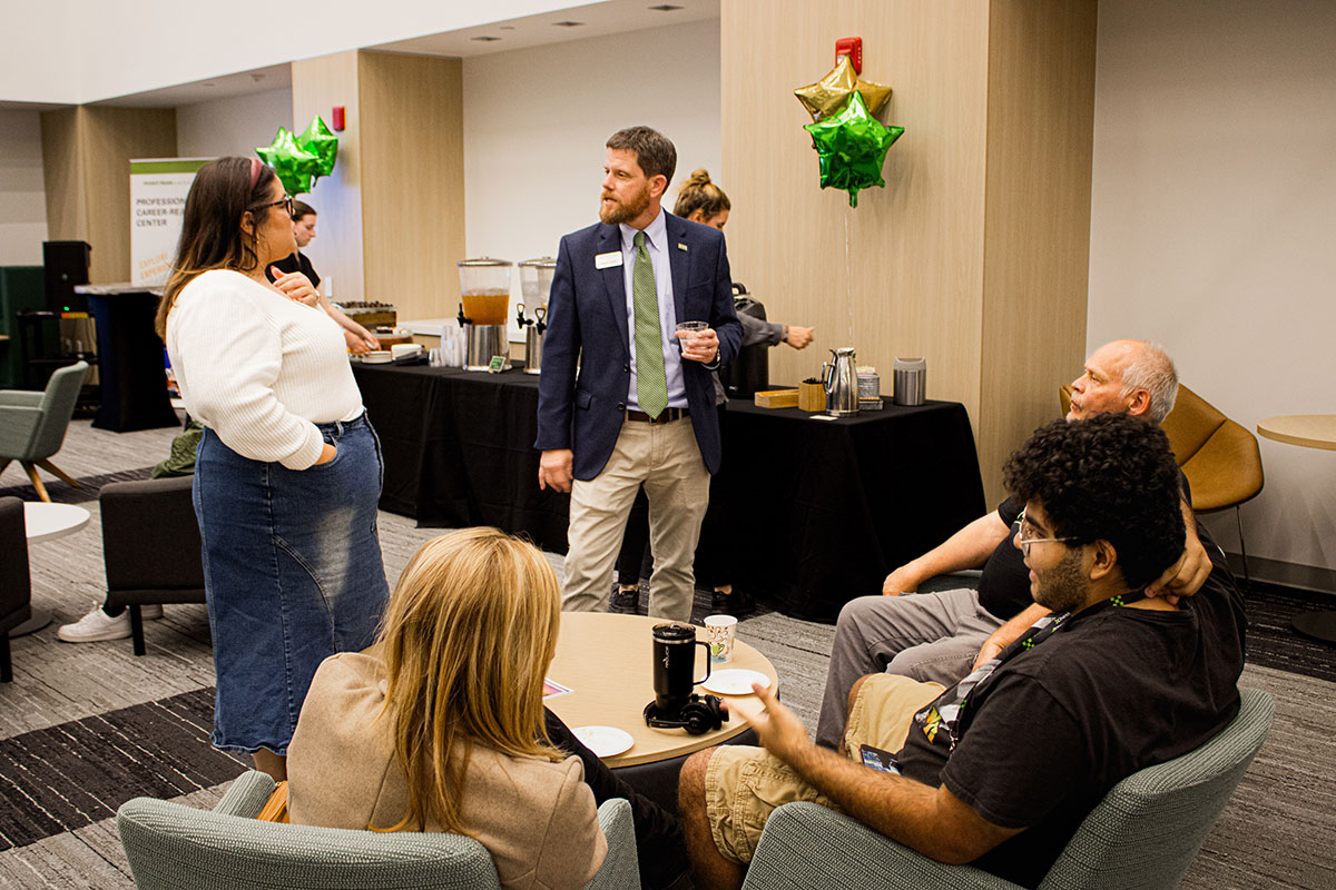 People at a reception in the Professional Career Readiness Center. 