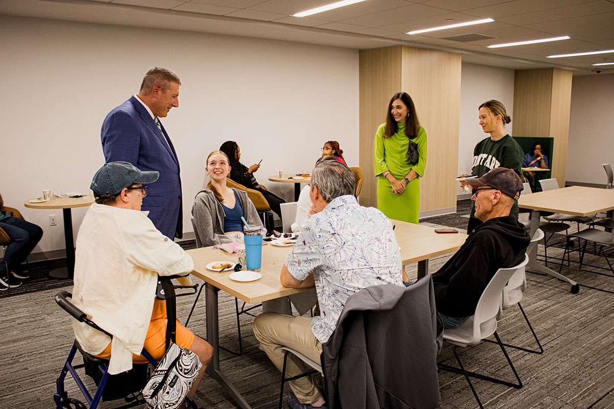 People at a reception in the Professional Career Readiness Center. 