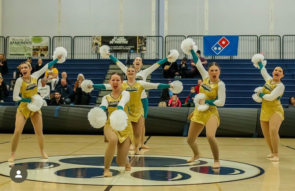 Cheer team on basketball court.