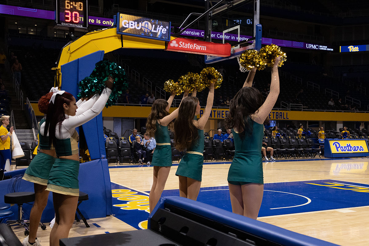 Cheerleaders on the sidelines of a game.