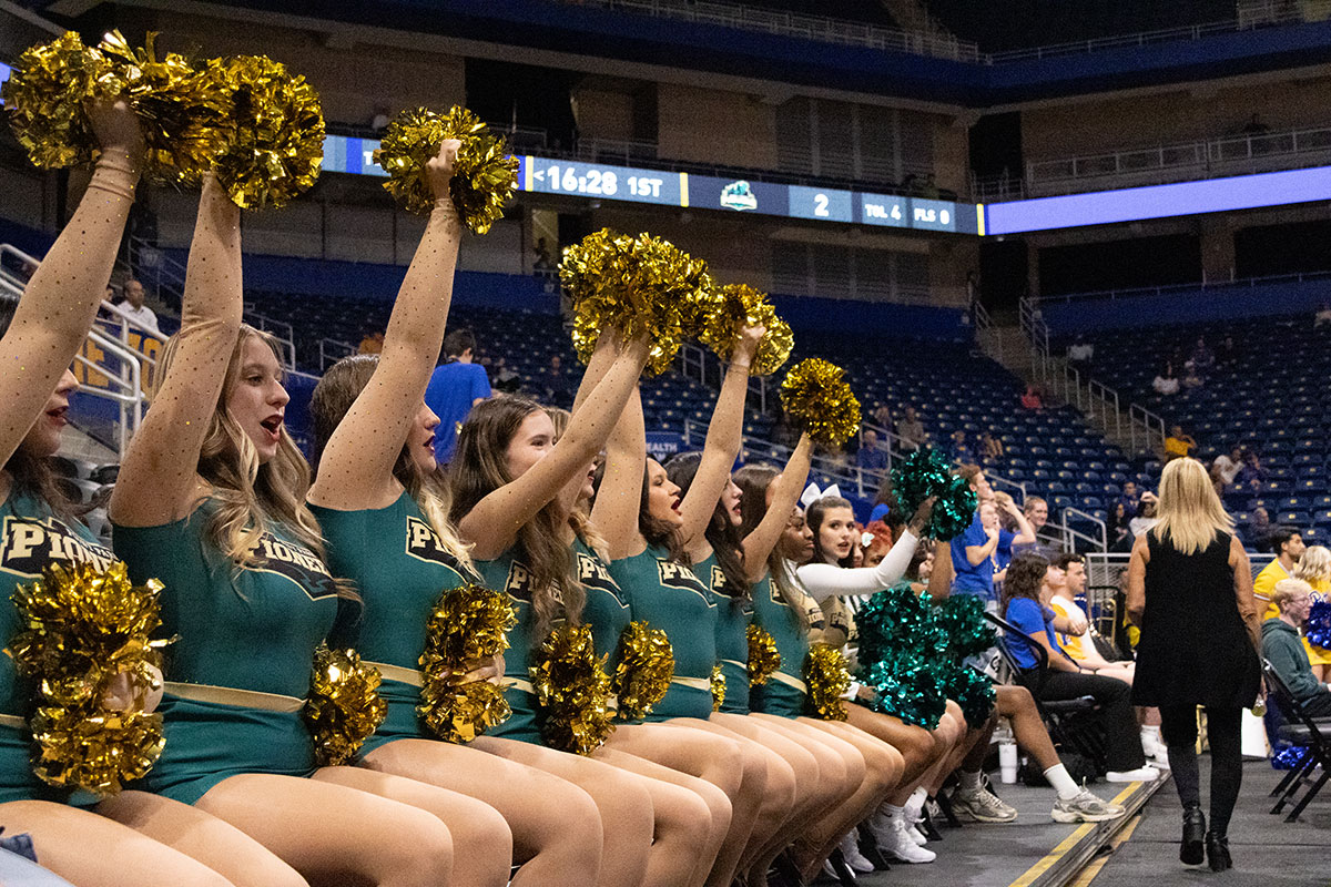 Cheerleaders on the sidelines of a game.