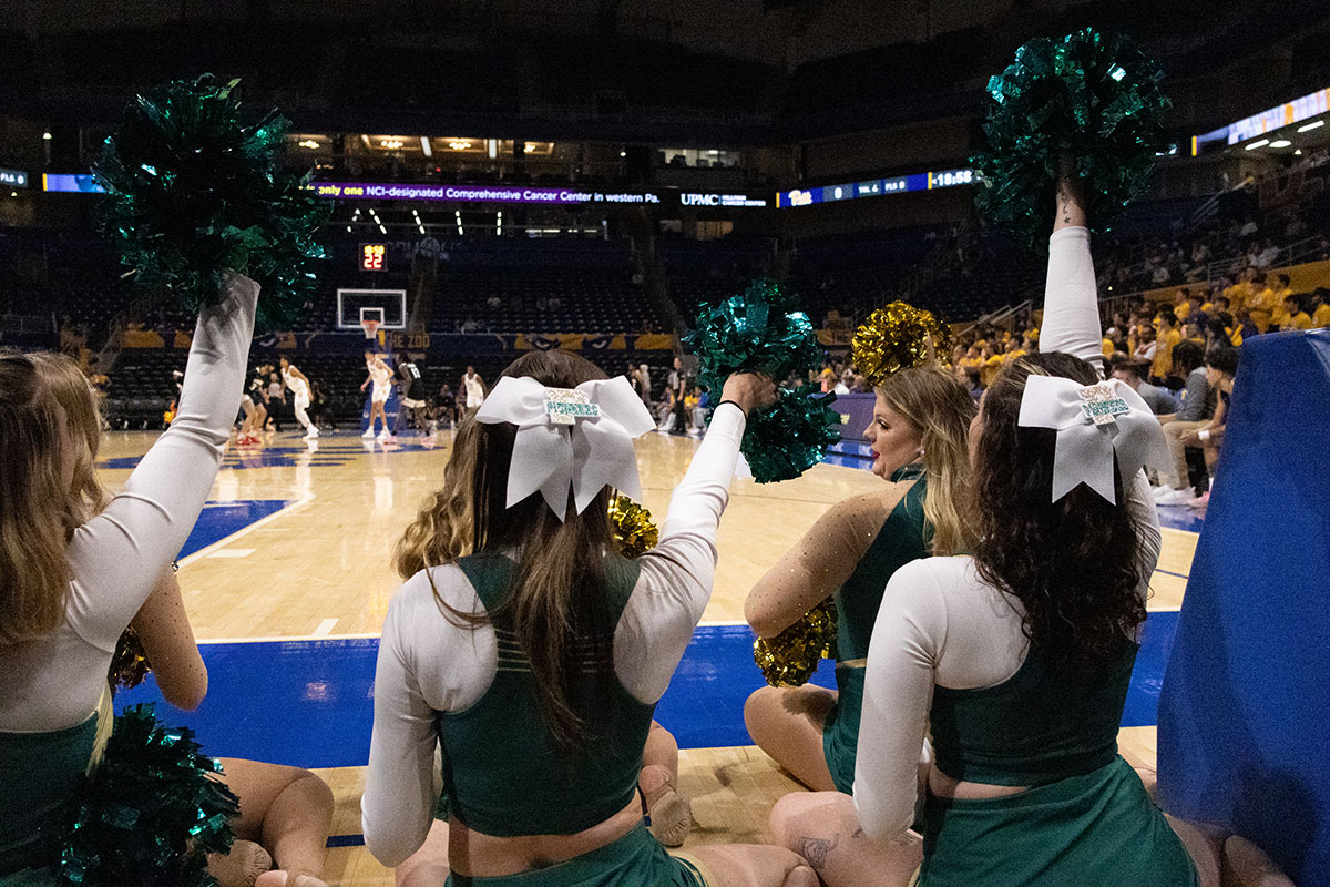 Cheerleaders on the sidelines of a game.