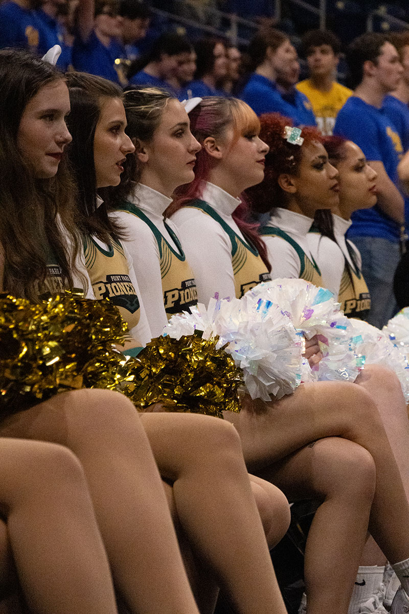 Cheerleaders on the sidelines of a game.