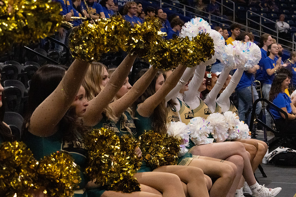 Cheerleaders on the sidelines of a game.