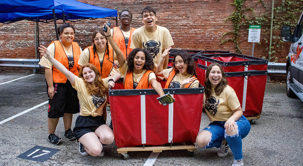 Students pose inside and around red bins